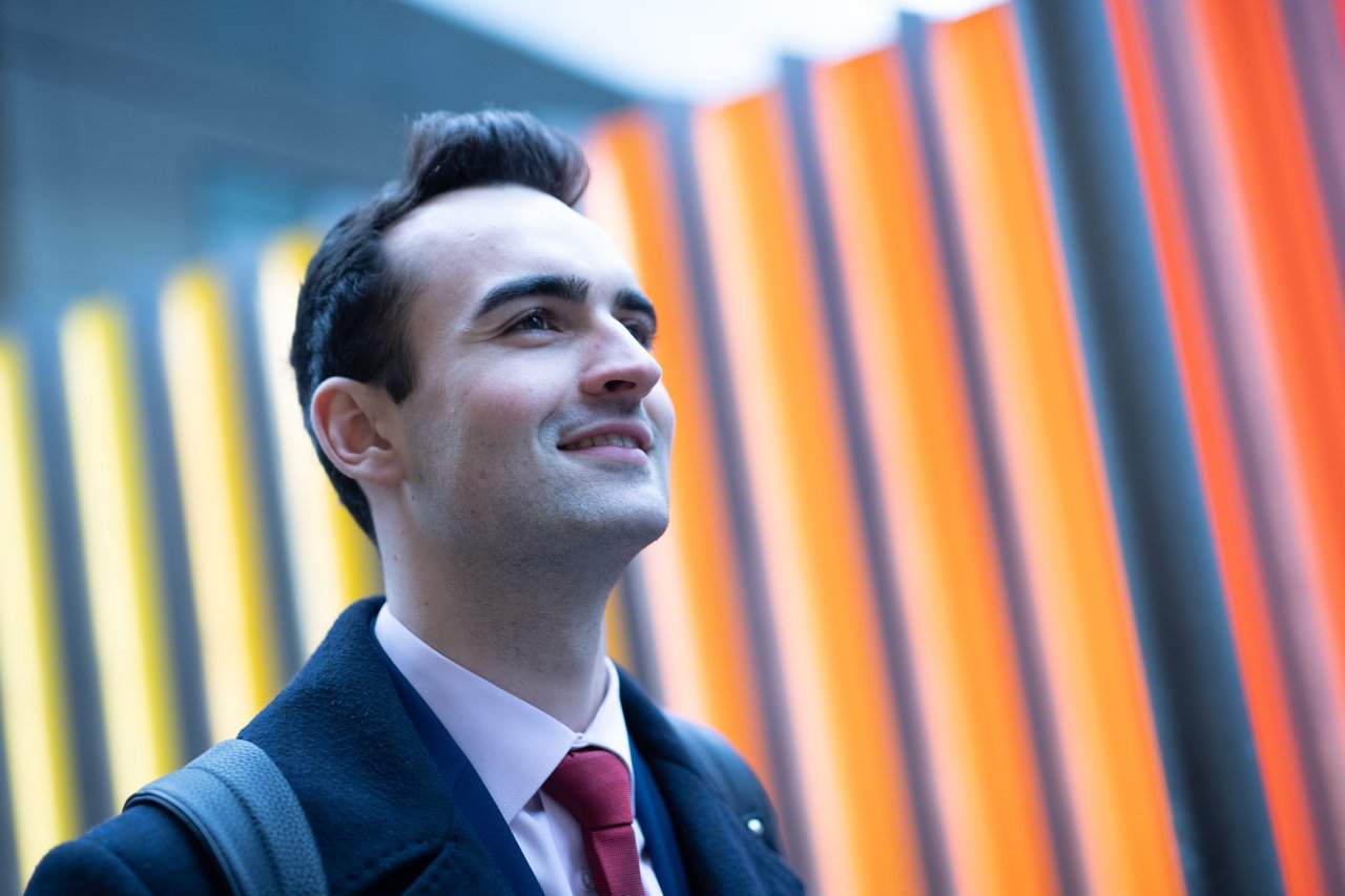Adam in front of a colorful wall