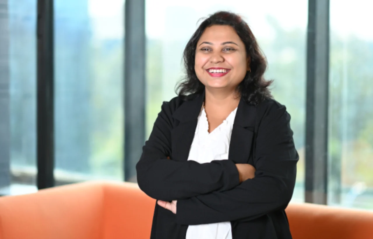 Woman stands close to window smiling