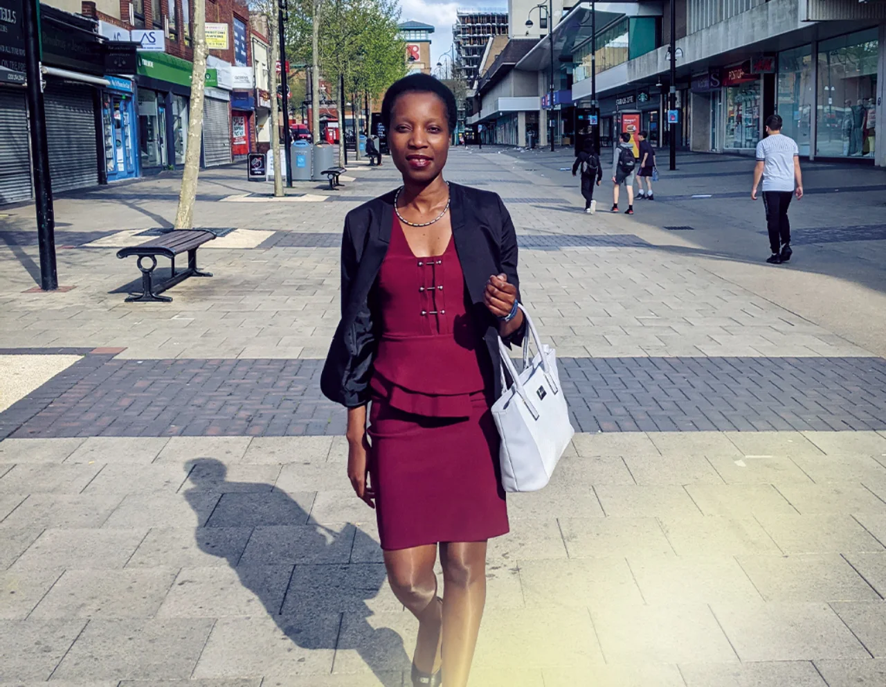 Melinda walks through a city centre