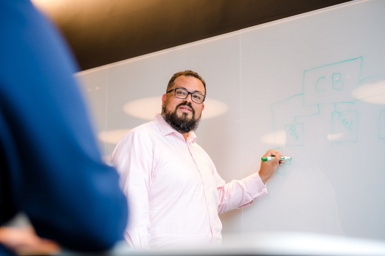 Man standing infront of white board