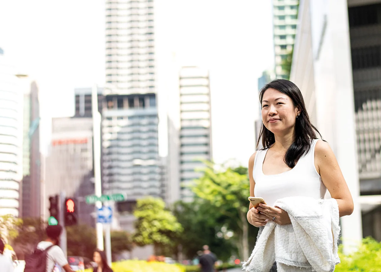 Wei Wei stands in the open air, surrounded by skyscrapers