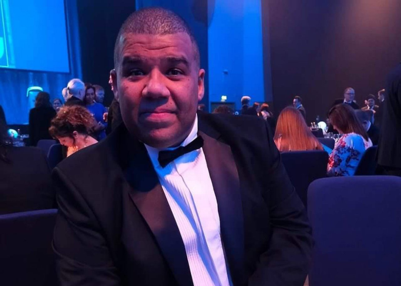 Tim George in the suit in award ceremony