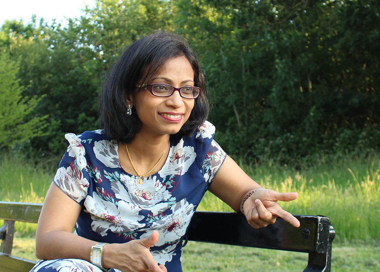 Sandhya on a park bench in conversation