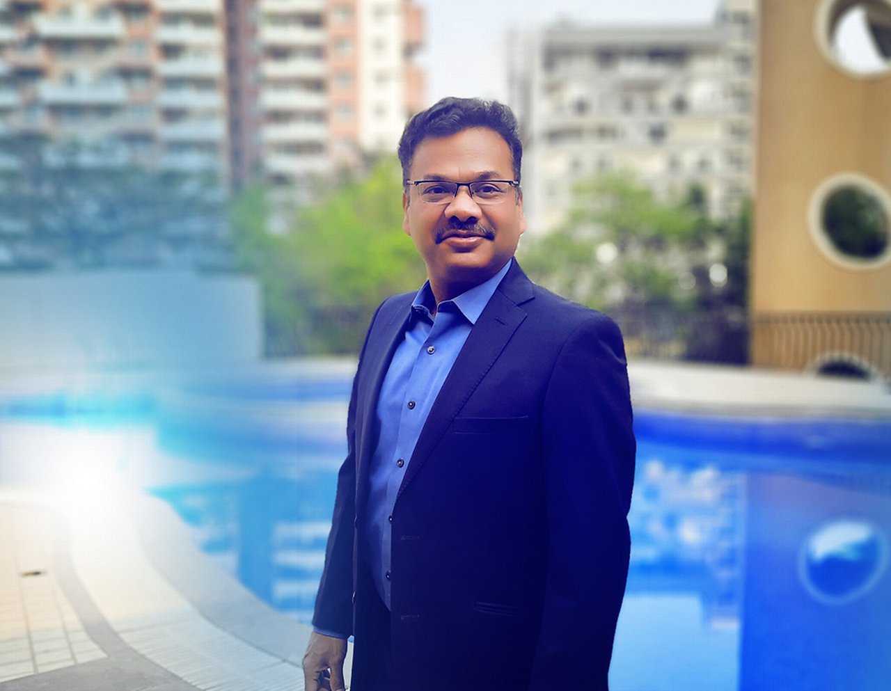 Rohit is standing by a swimming pool