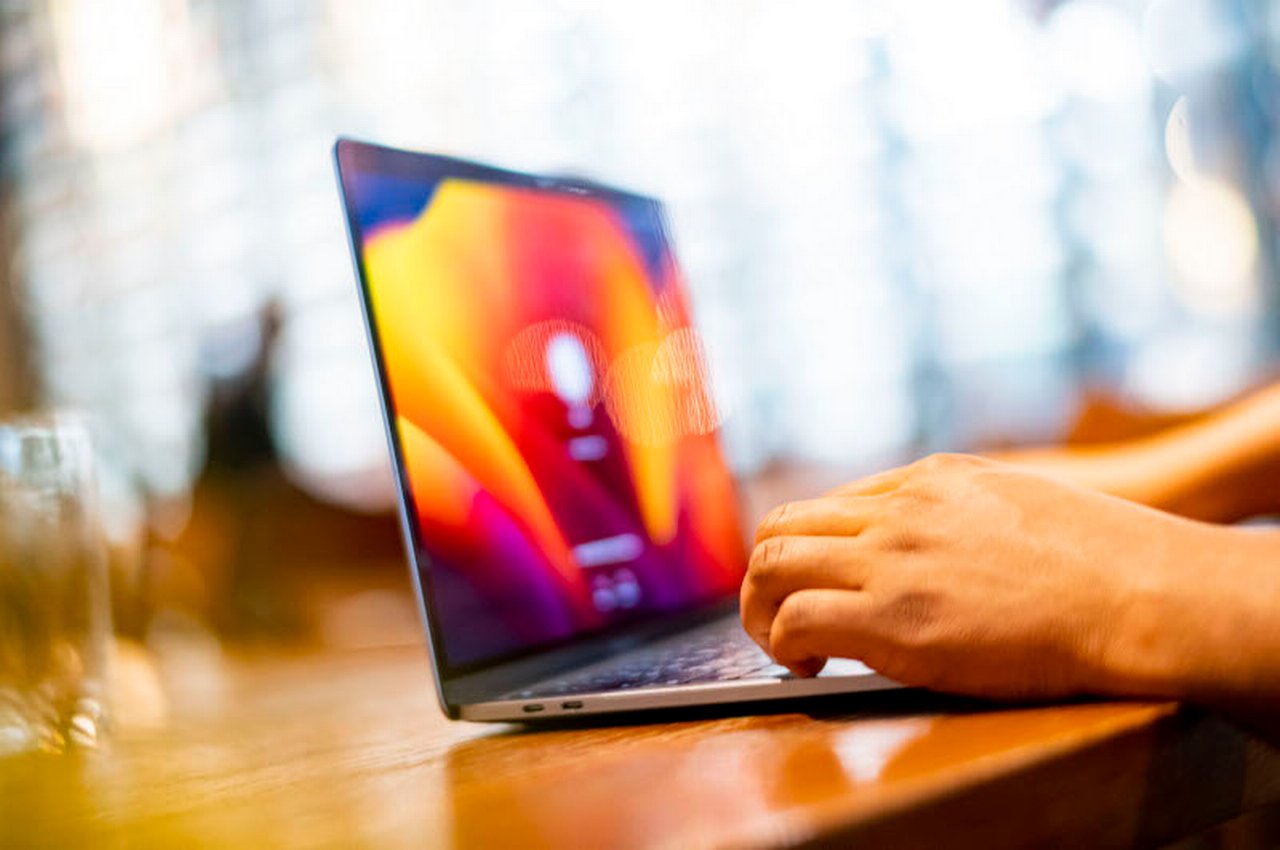 Hands on an open laptop