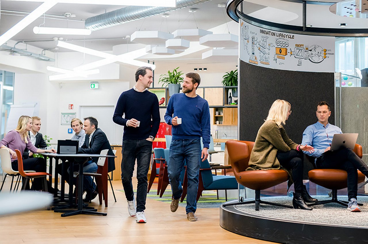 different people sit and stand in a working café in Berlin