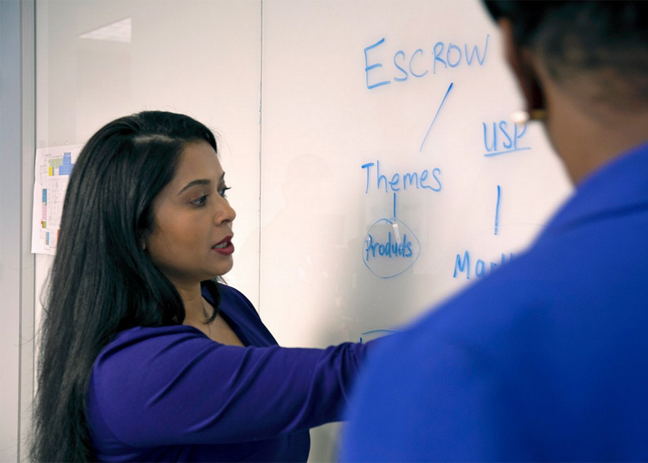 Kamalita taking notes on a whiteboard with Kisha