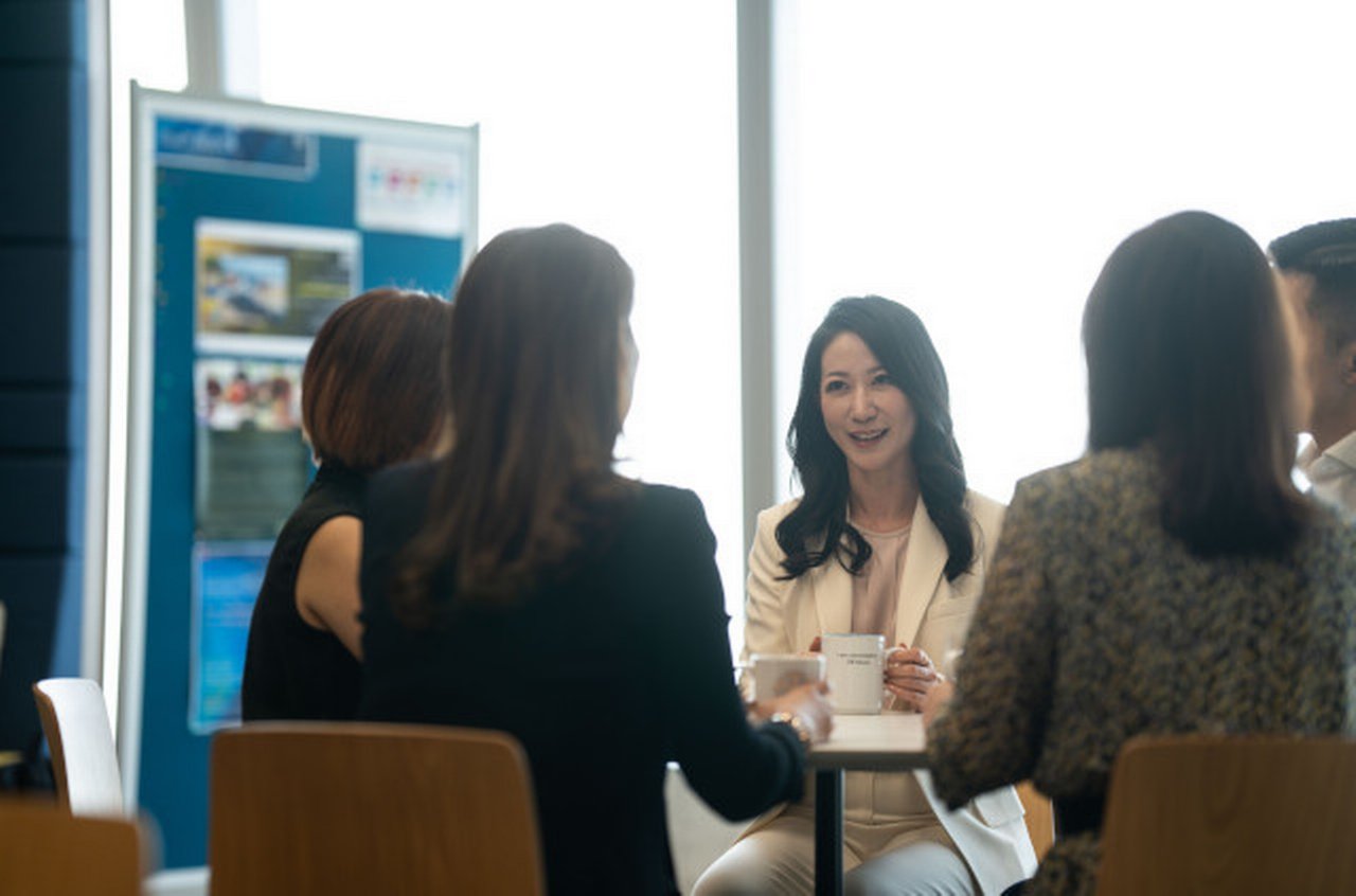Colleagues exchanging a lighter moment at Deutsche Bank office in Hong Kong