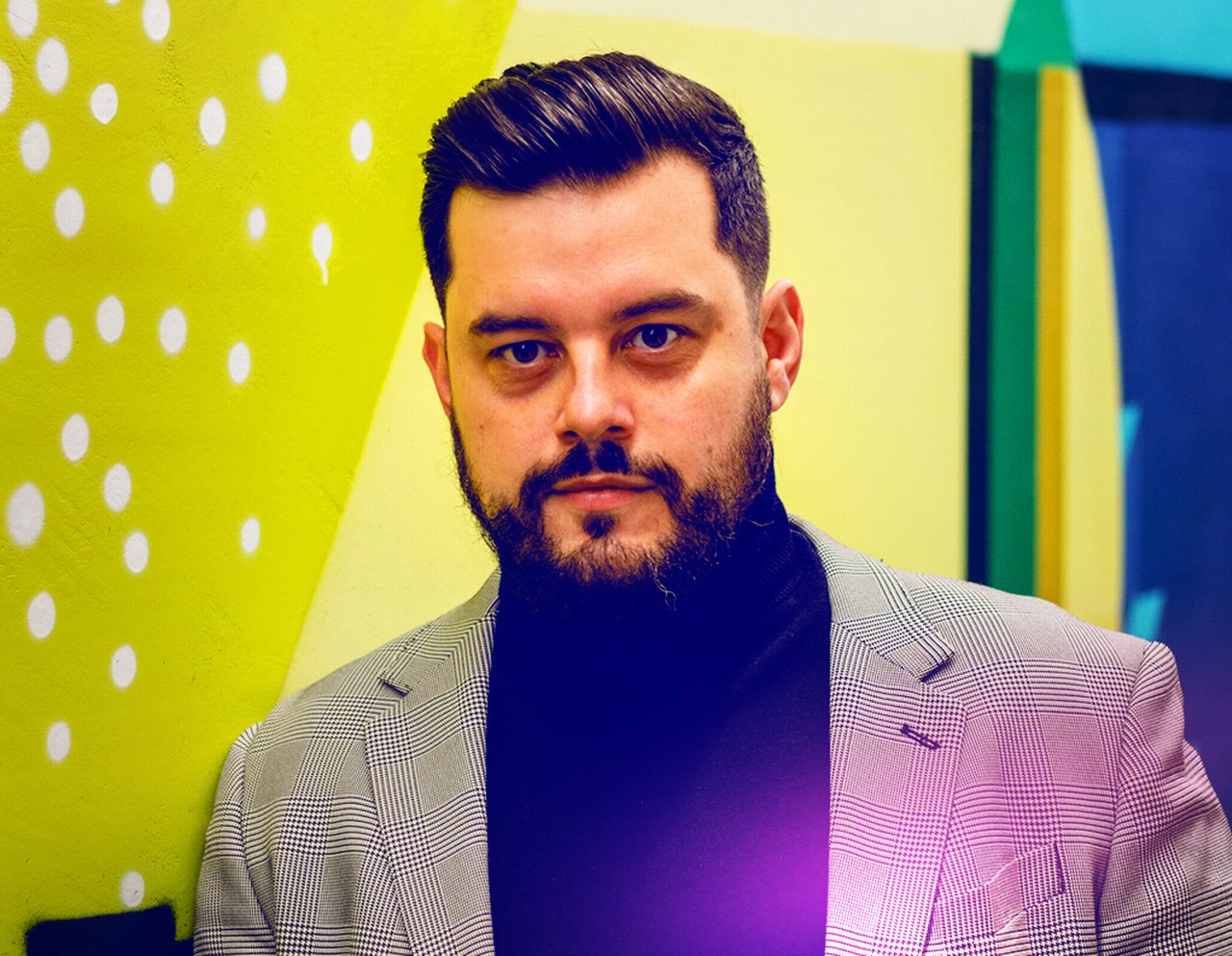Mihai in front of a yellow background