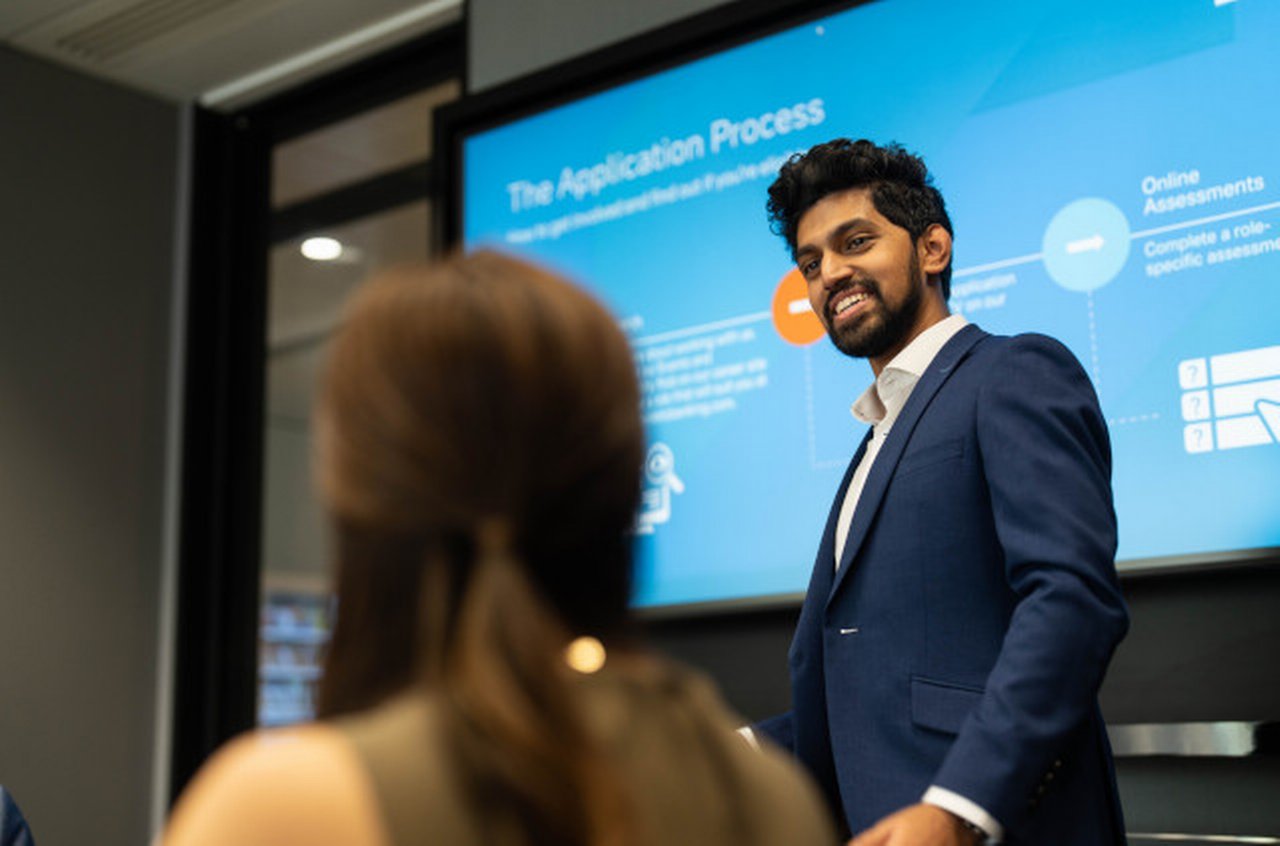 Talenthub - man holds a presentation in conference room at Deutsche Bank office in Hong Kong