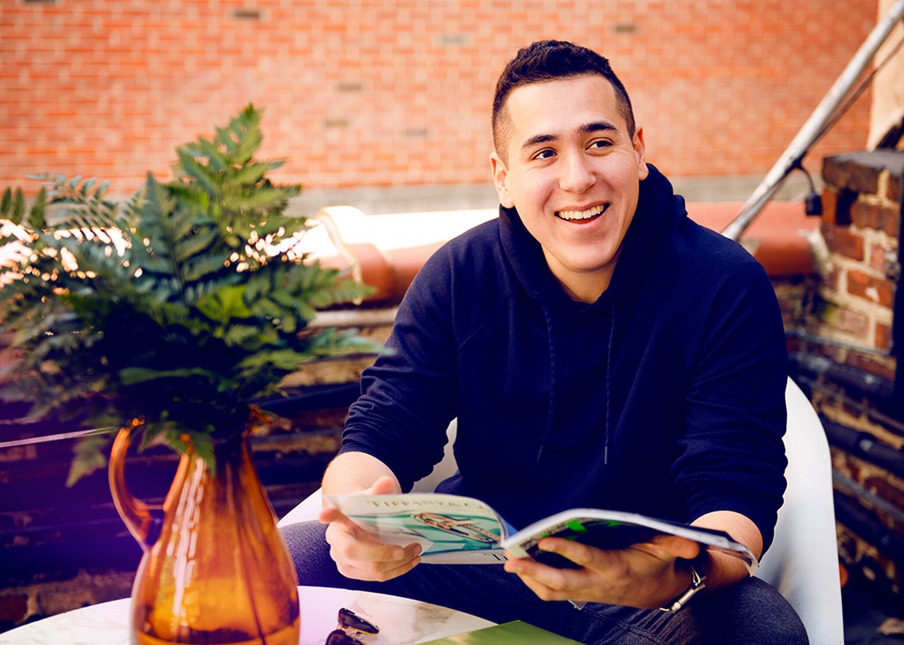 Dave at a table in front of a brick wall
