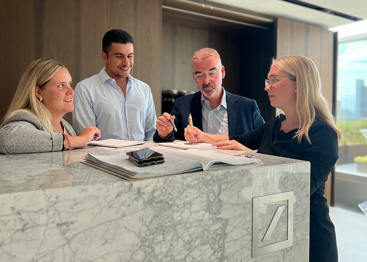 Lisa in conversation with three colleagues