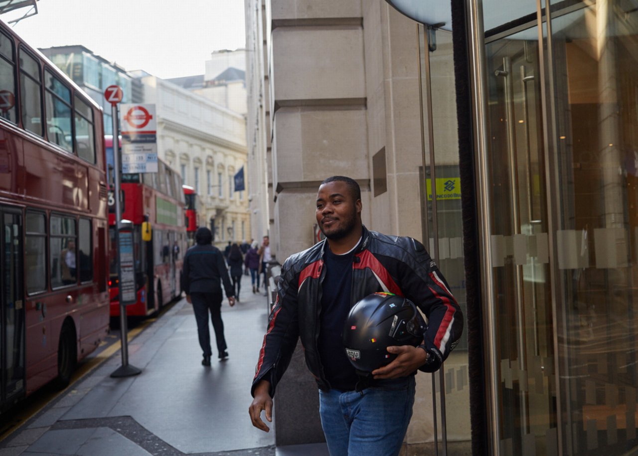 Selasi with motorbike helmet in his hand in London