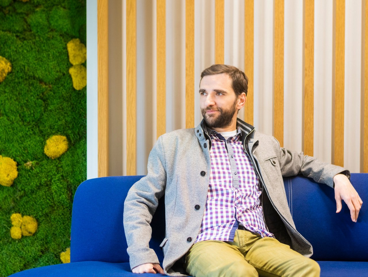 Man sitting on a blue sofa