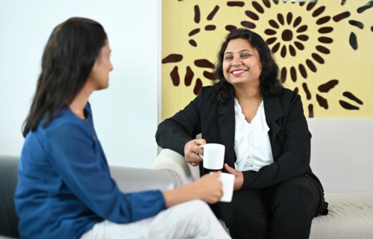 Two woman in conversation on the lobby couch