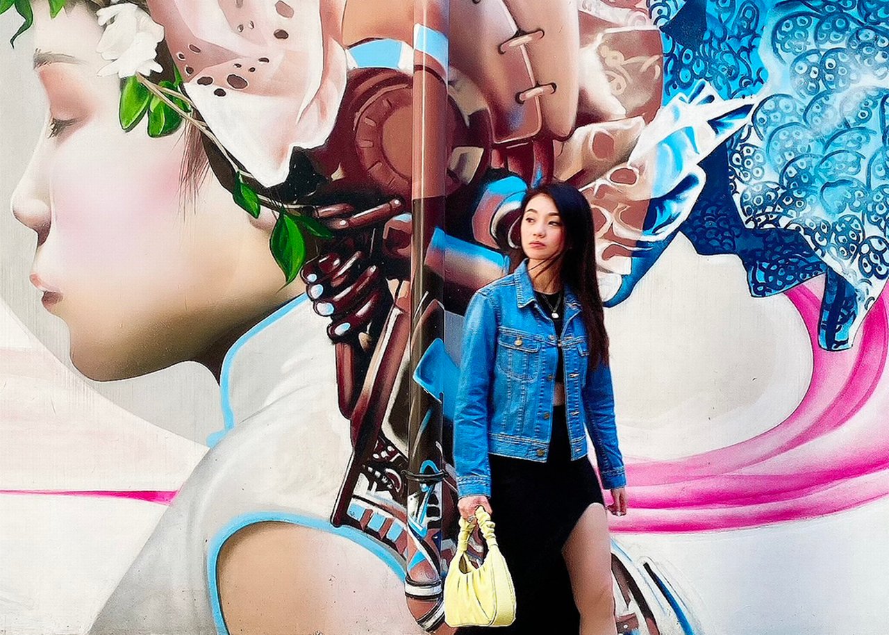 Katherine in front of a big wall picture