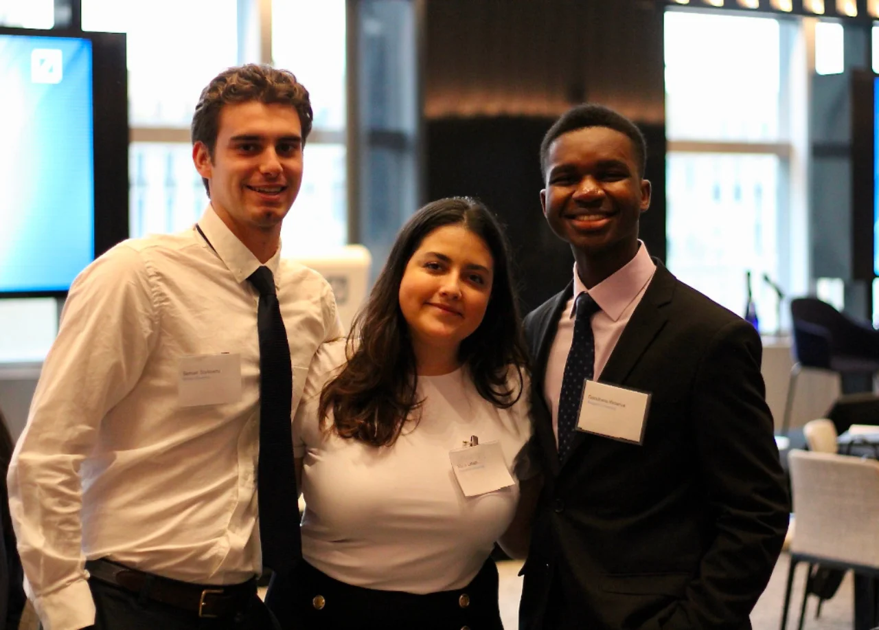 Three graduates smiling