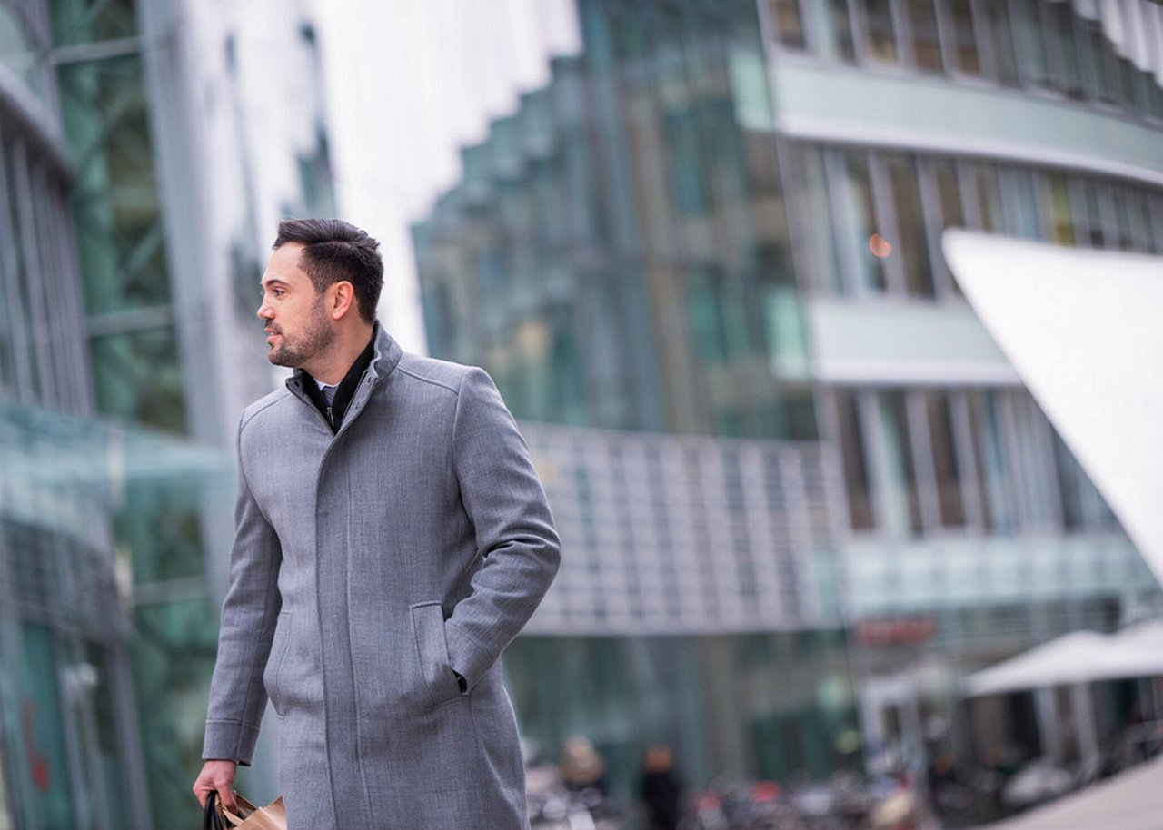 Semi is standing outside of a glass building