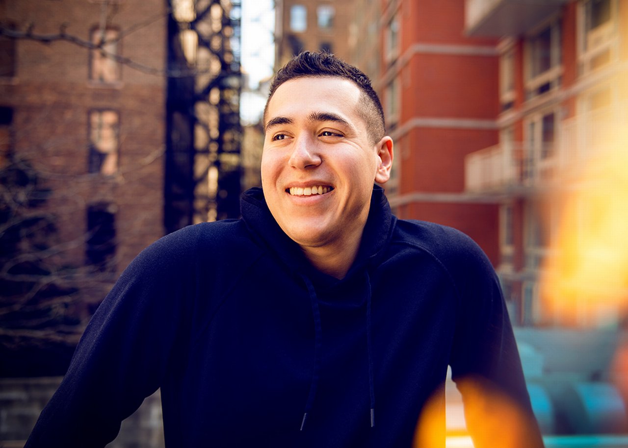 Dave smiling in front of two blocks
