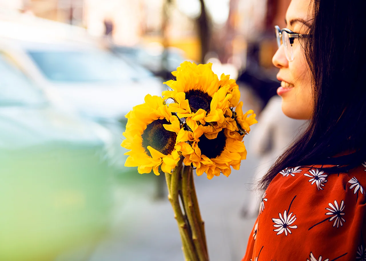 Tina with a bouquet of sunflowers