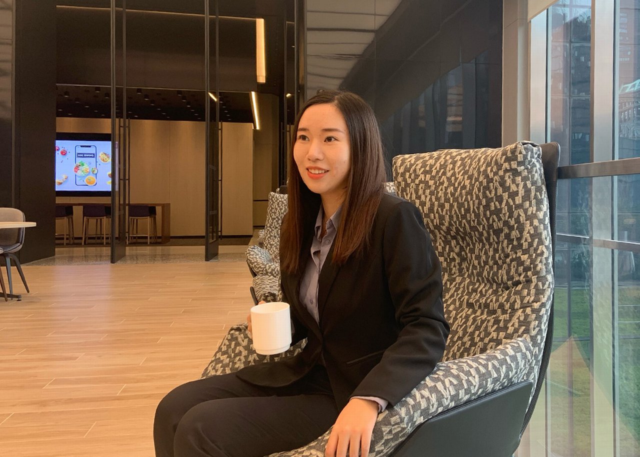 Woman sitting on chair with tea cup in hand