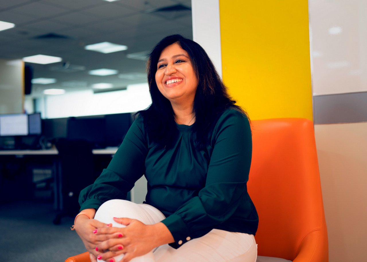 Woman sit in the office smiling