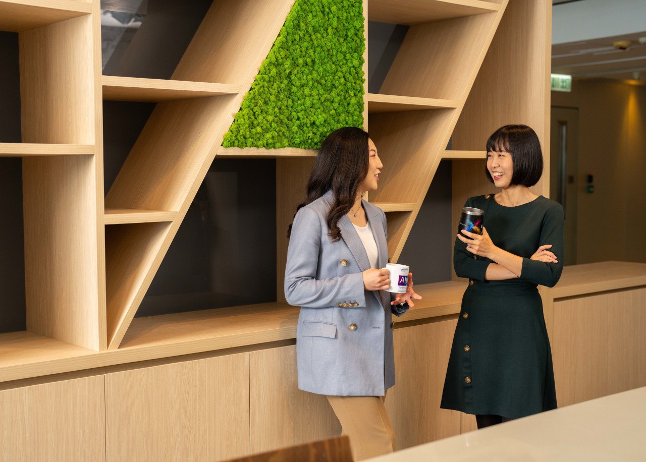Women colleagues interacting at Deutsche Bank office in Hong Kong