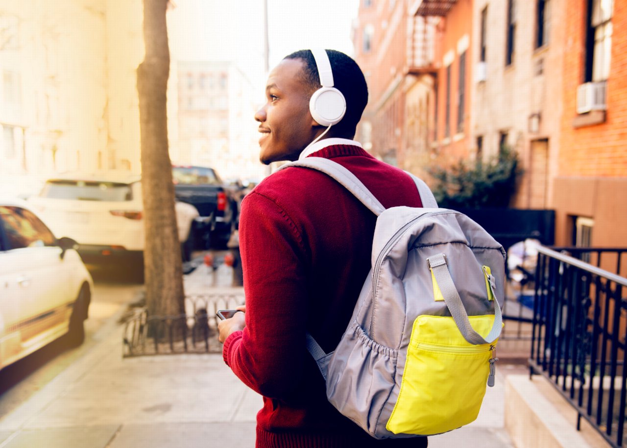Jerry with headphones on and a backpack