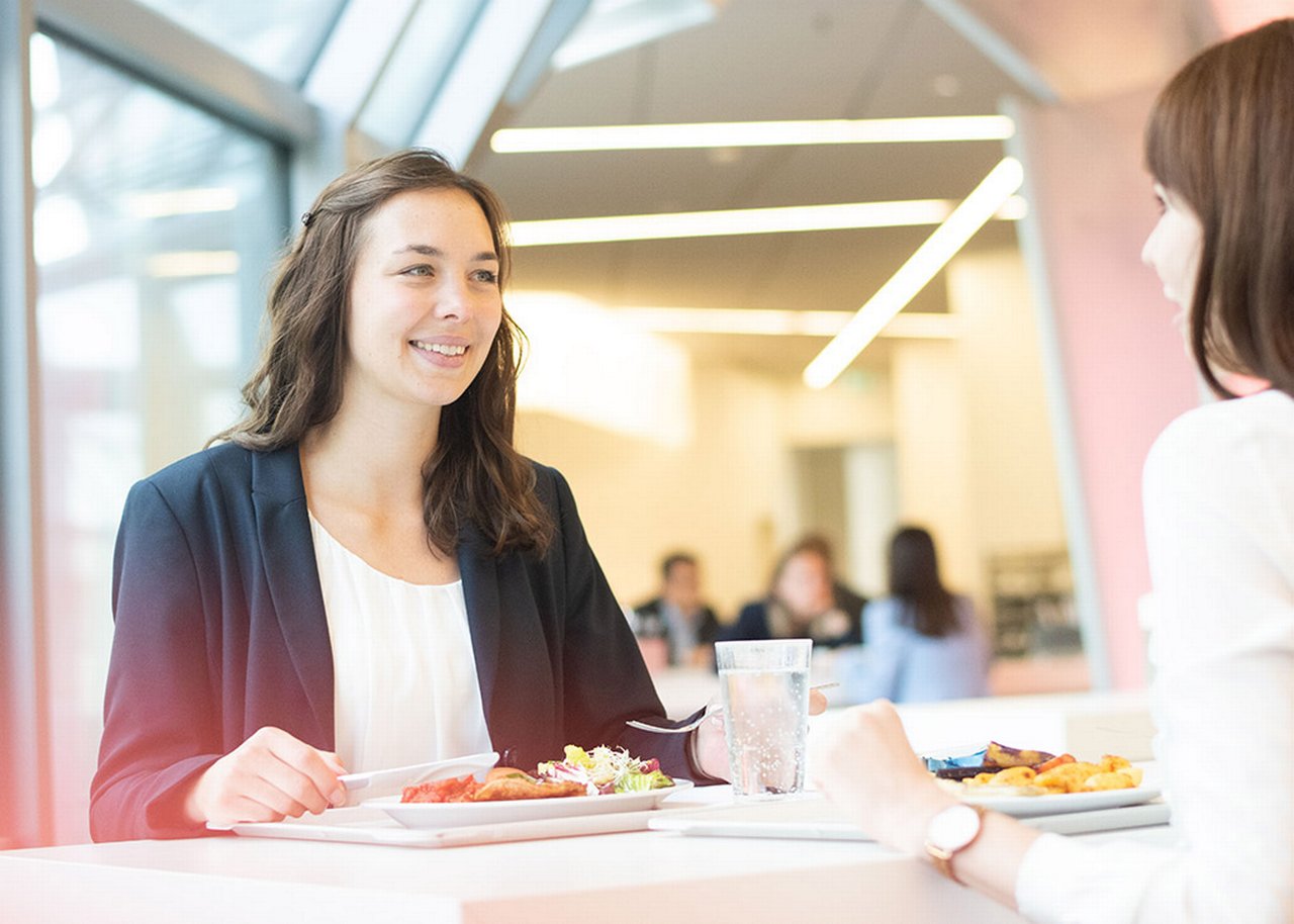 Giulia smiling at lunch with a colleague