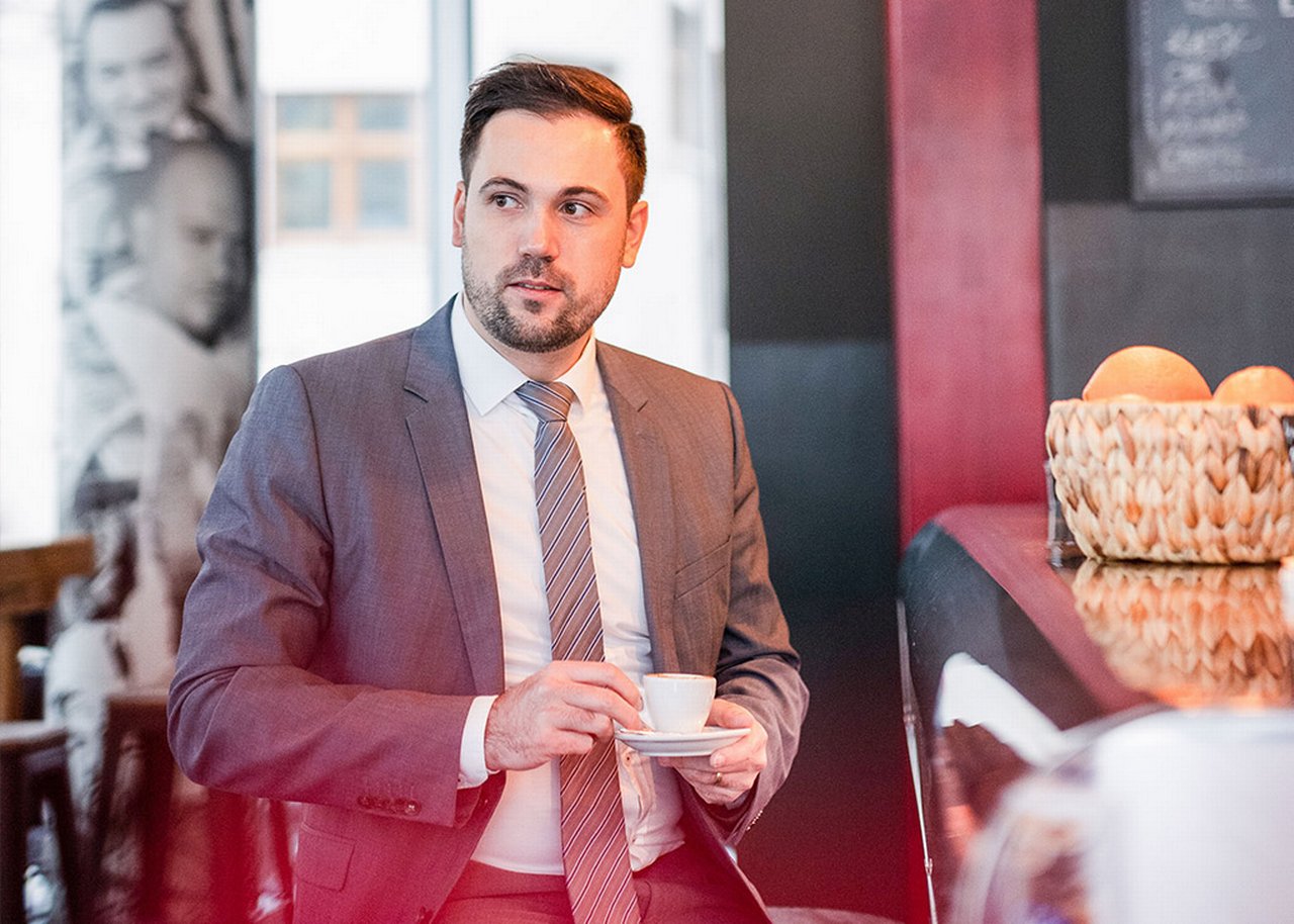 Semi is standing with a cup of espresso in his hand