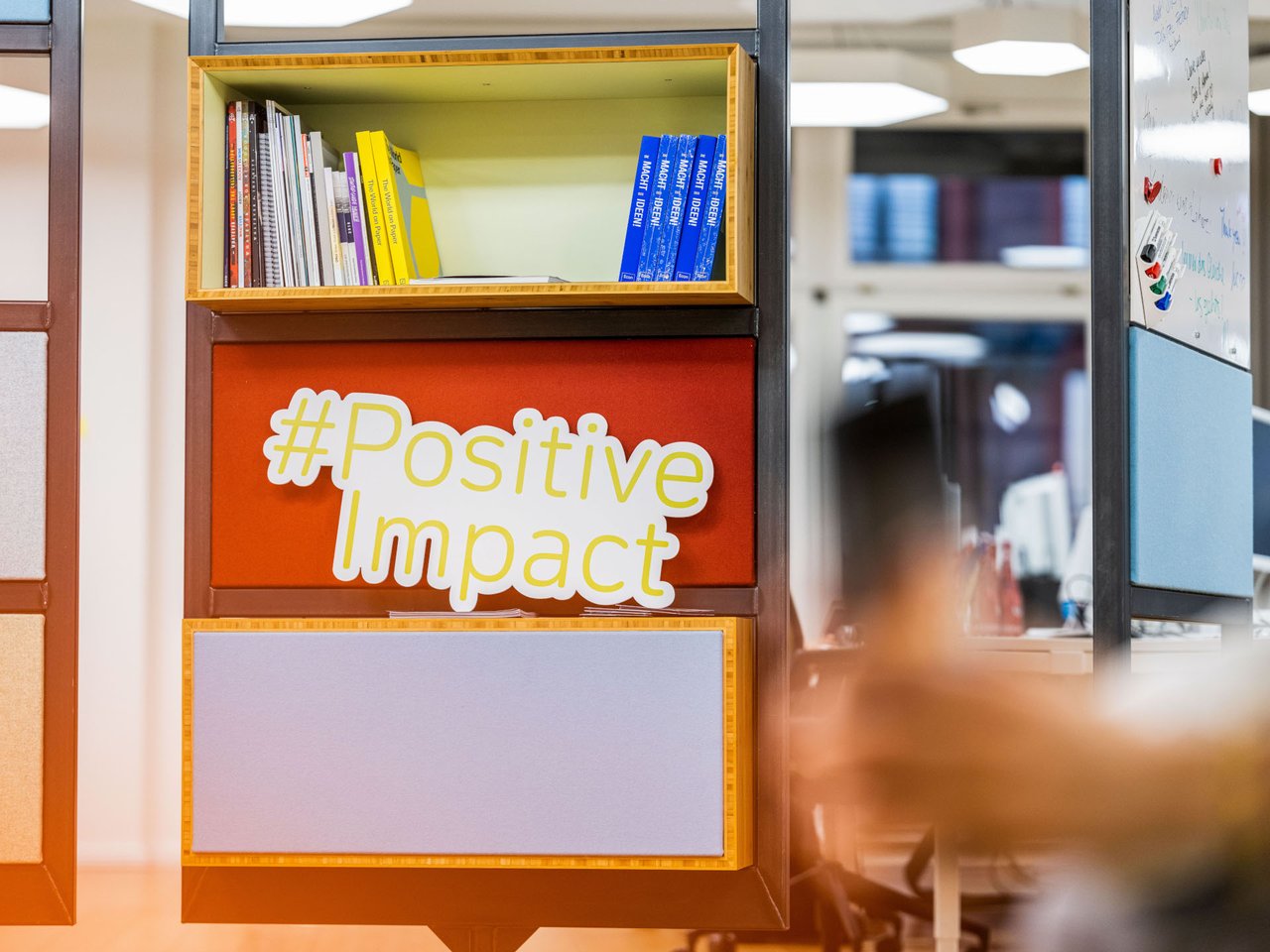 Shelve with books and hashtag Positive Impact Poster