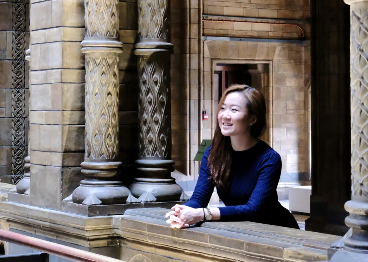 Queenie in a museum smiling