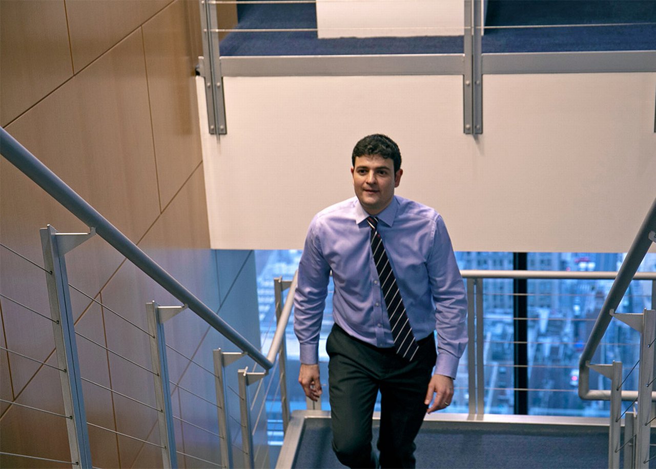 Mike walking up a flight of stairs