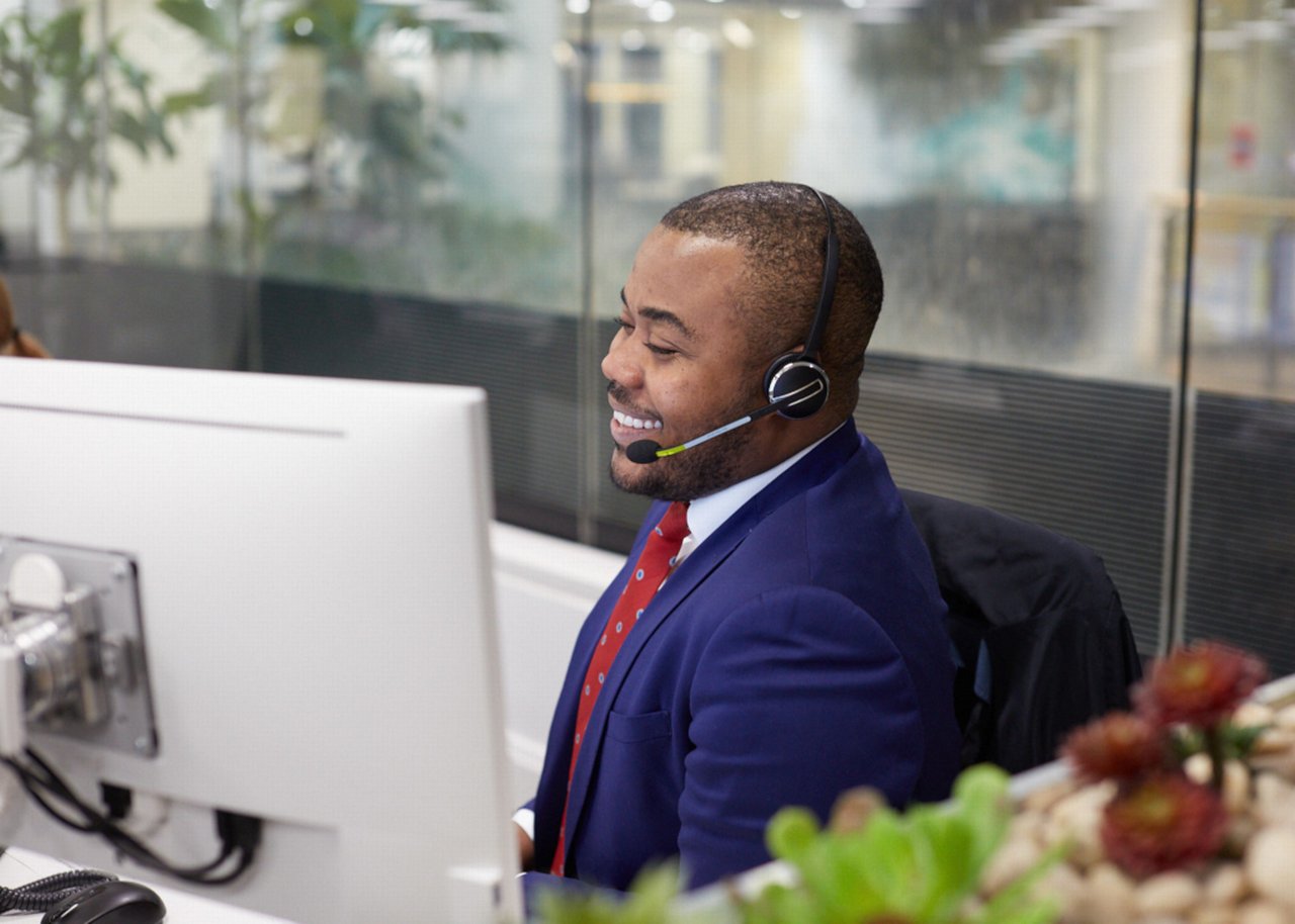 Selasi wears a headset and smiles in an online meeting