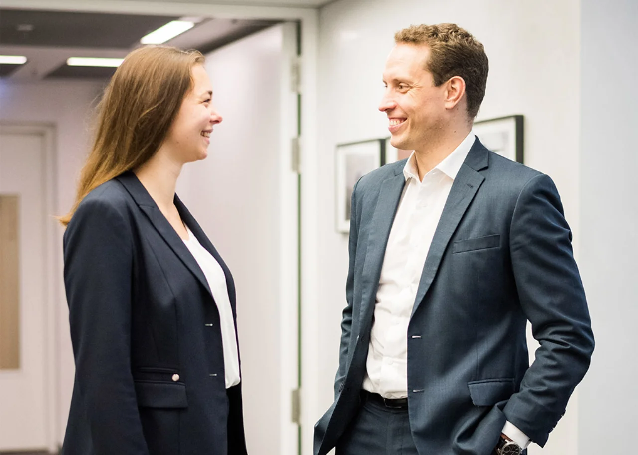 Giulia smiling in conversation with a colleague
