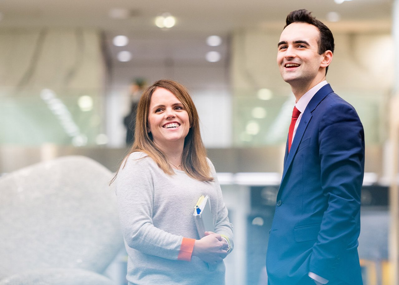 Sarah and a colleague looking on smiling