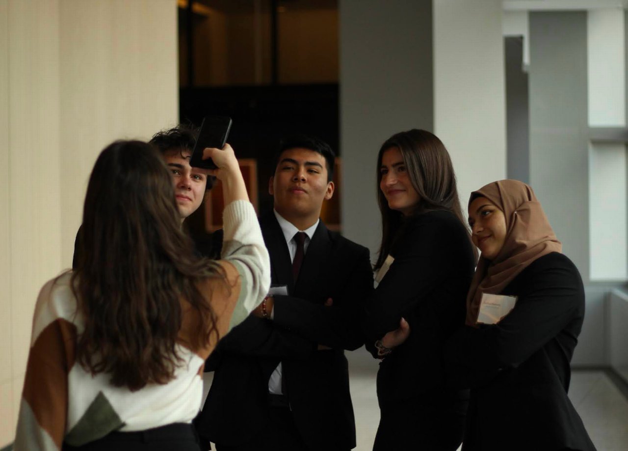 Group of students is photographed with a smartphone