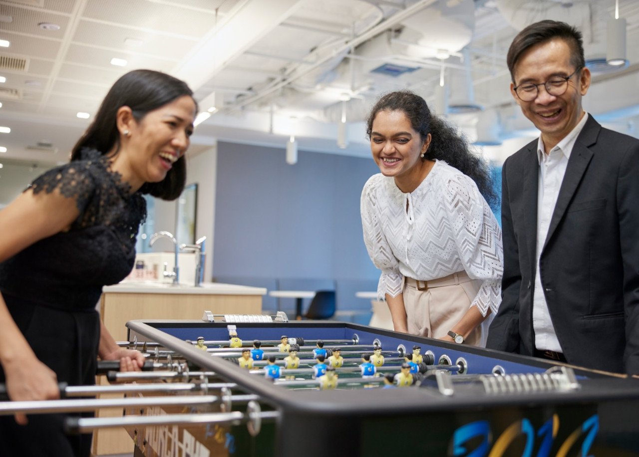 Colleagues playing kicker in office