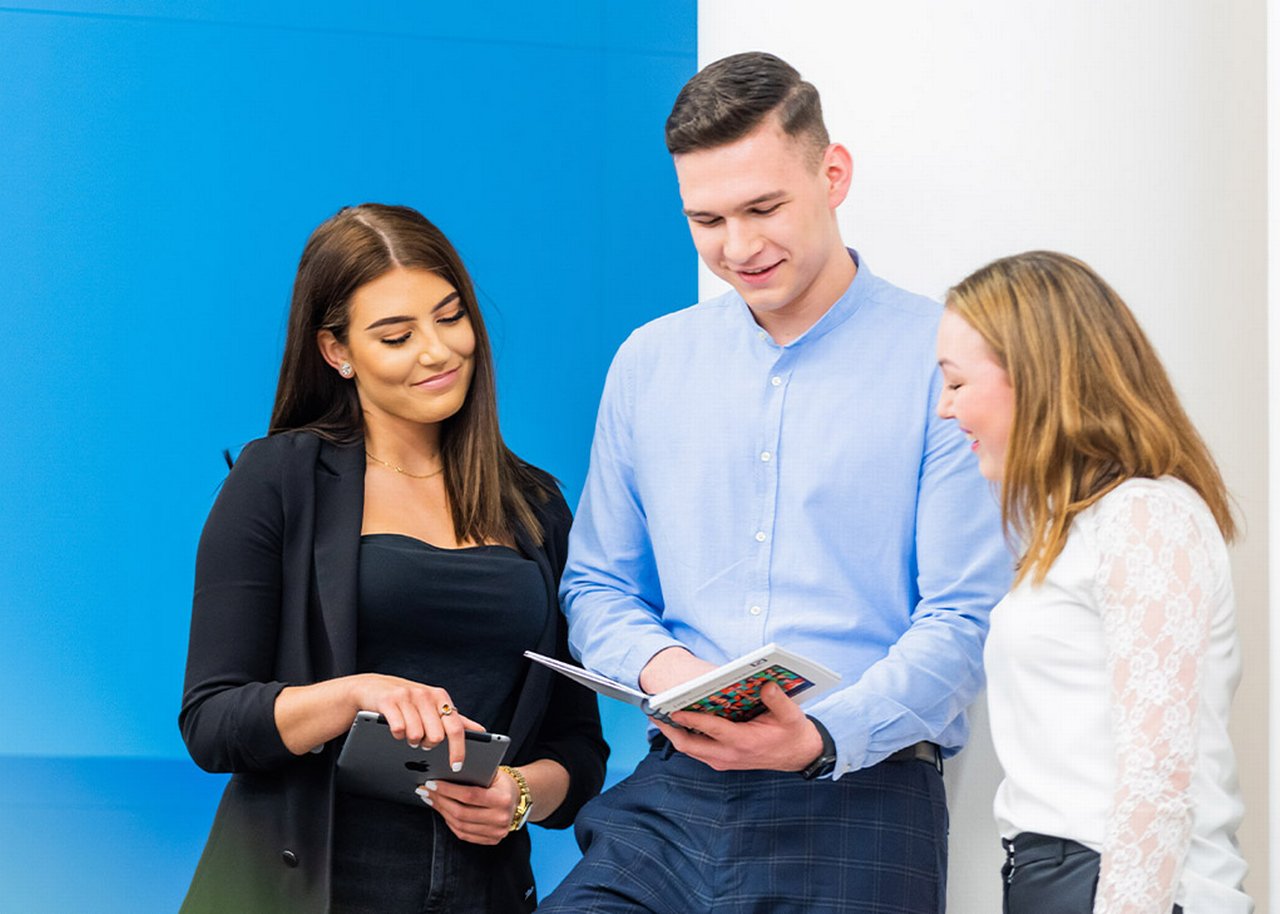 Justin showing his notes to colleagues