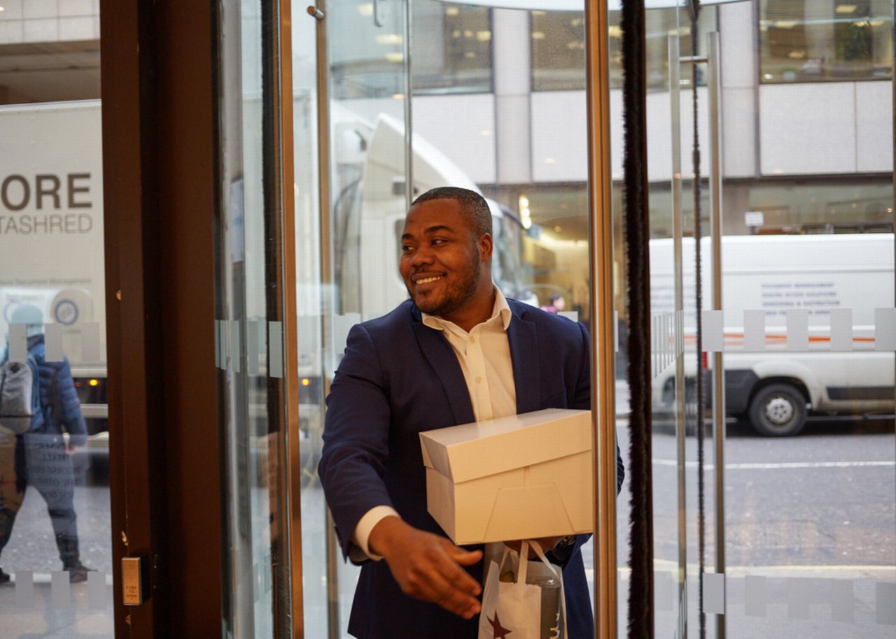 Selasi comes through the door with a smile and carries a package
