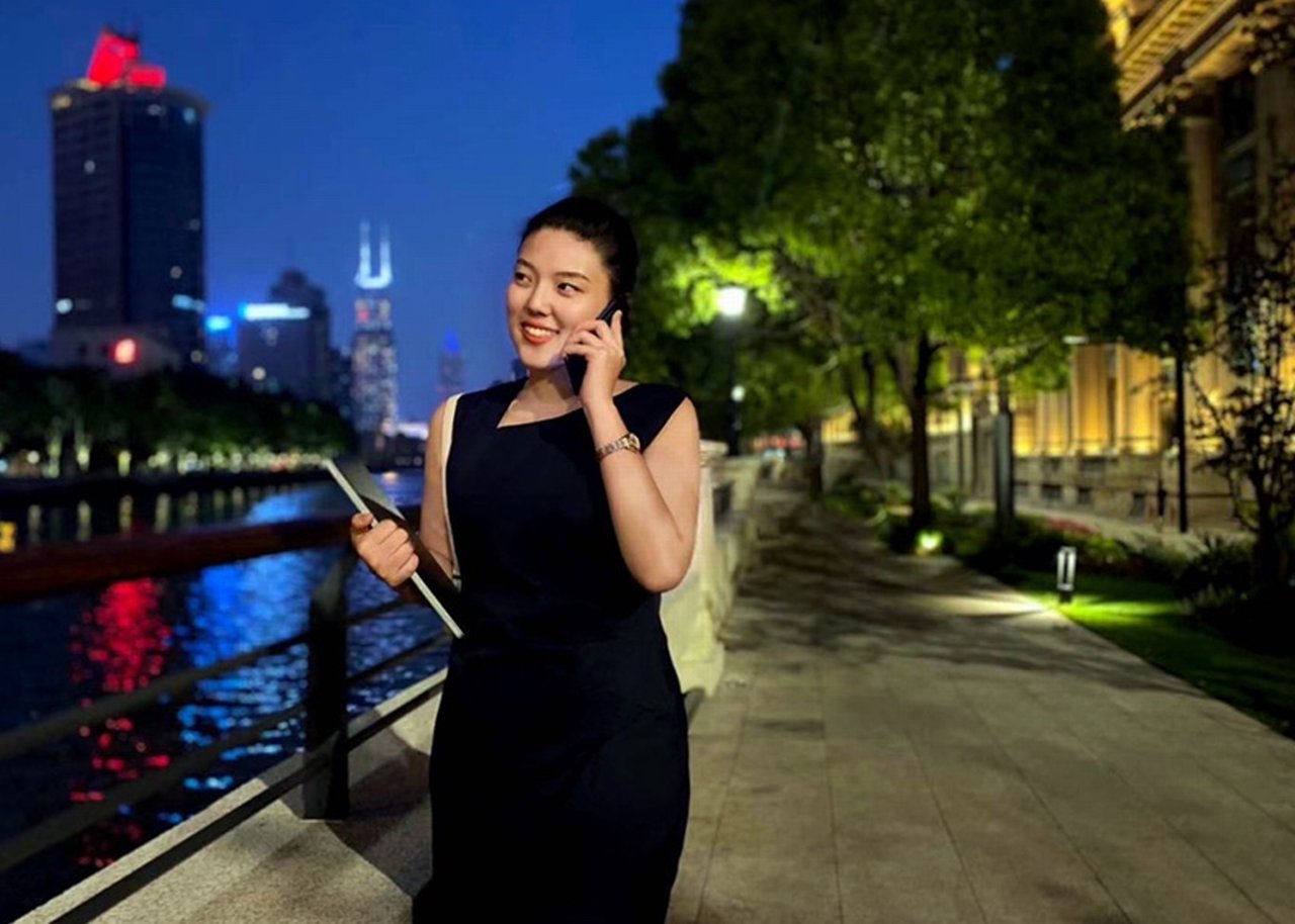 Tori is on the phone on the riverbank