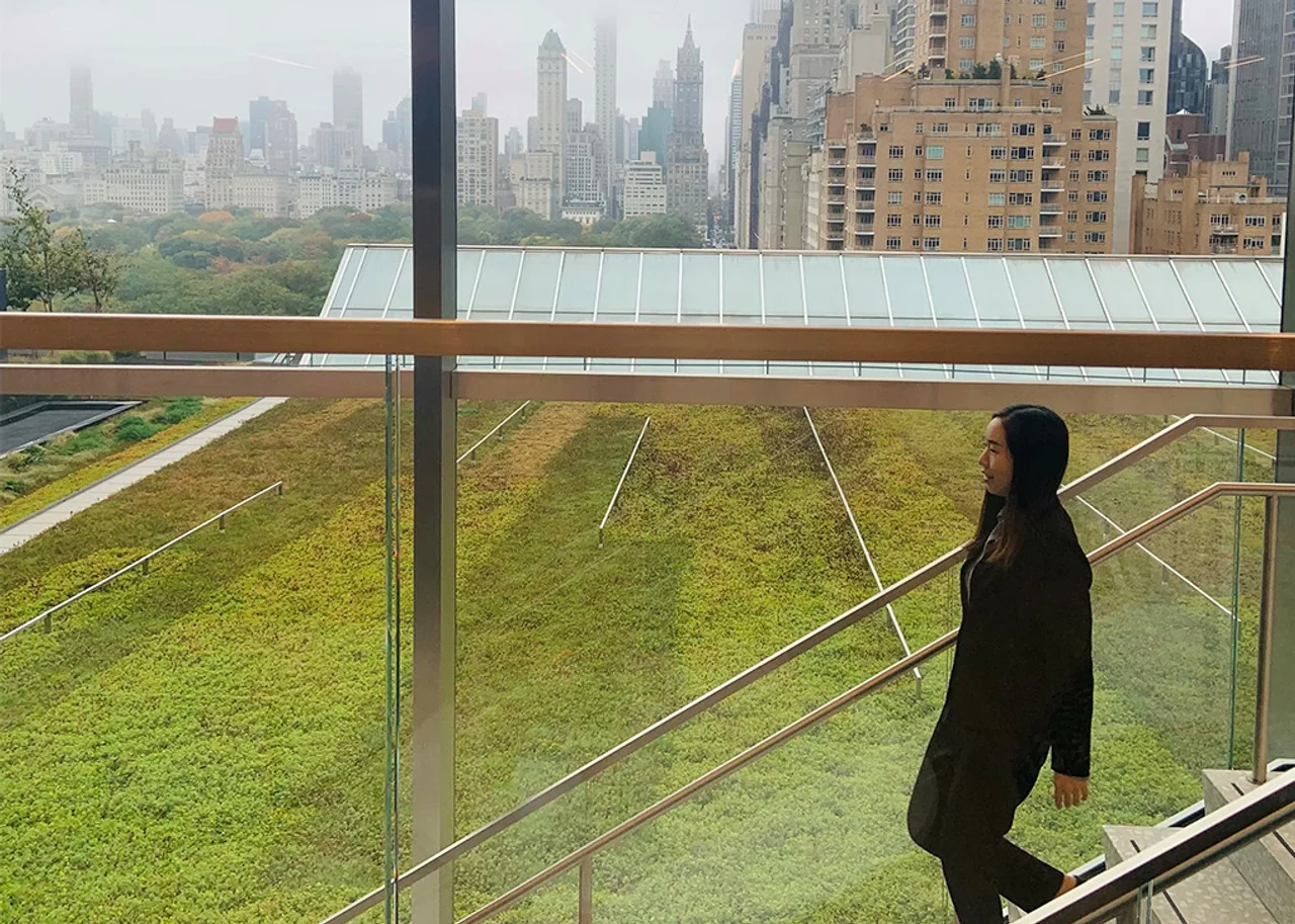 woman walking down stairs, glass window in the background