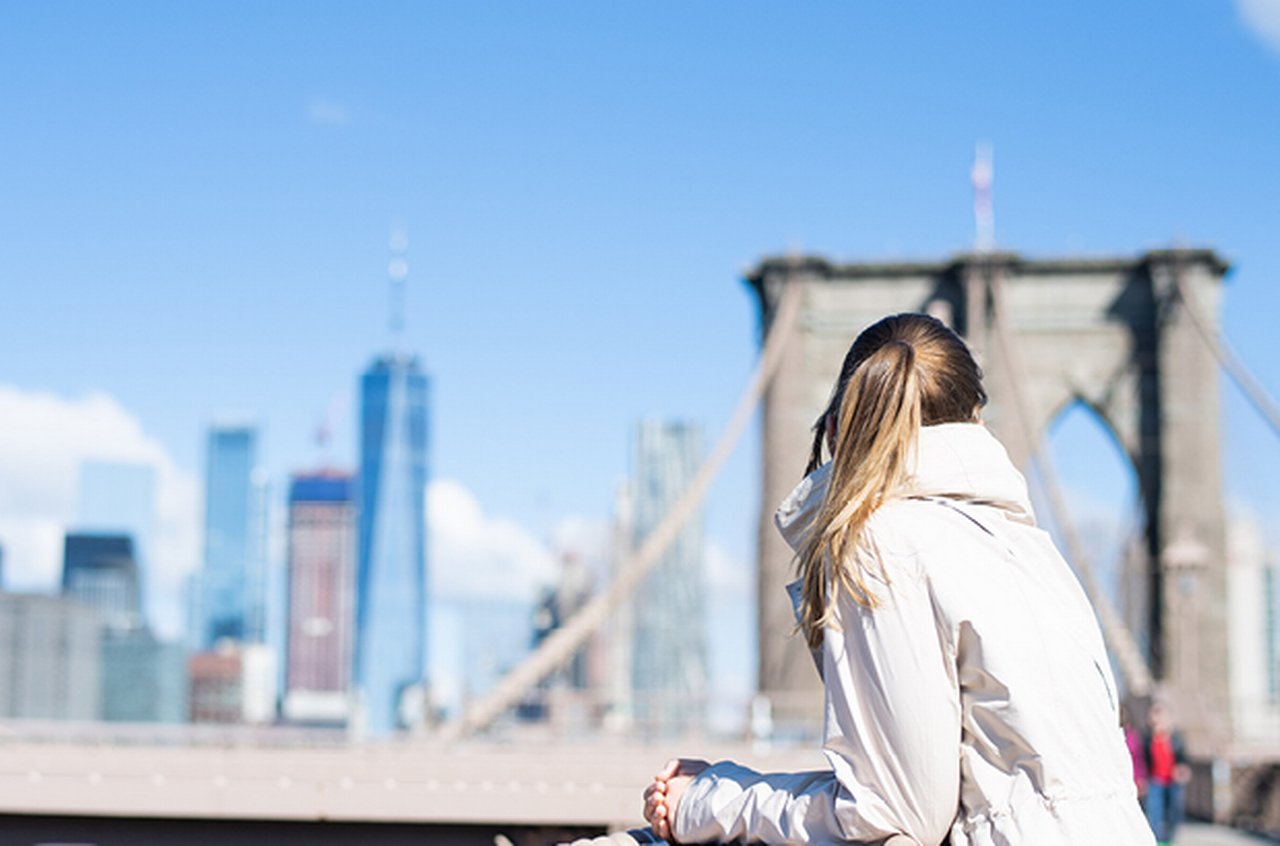 Woman sitting on a bridge