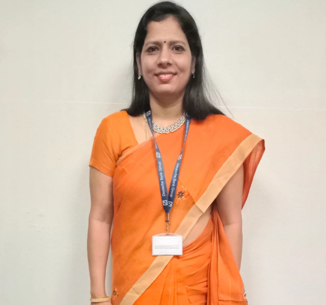 Lakshmi standing and smiling