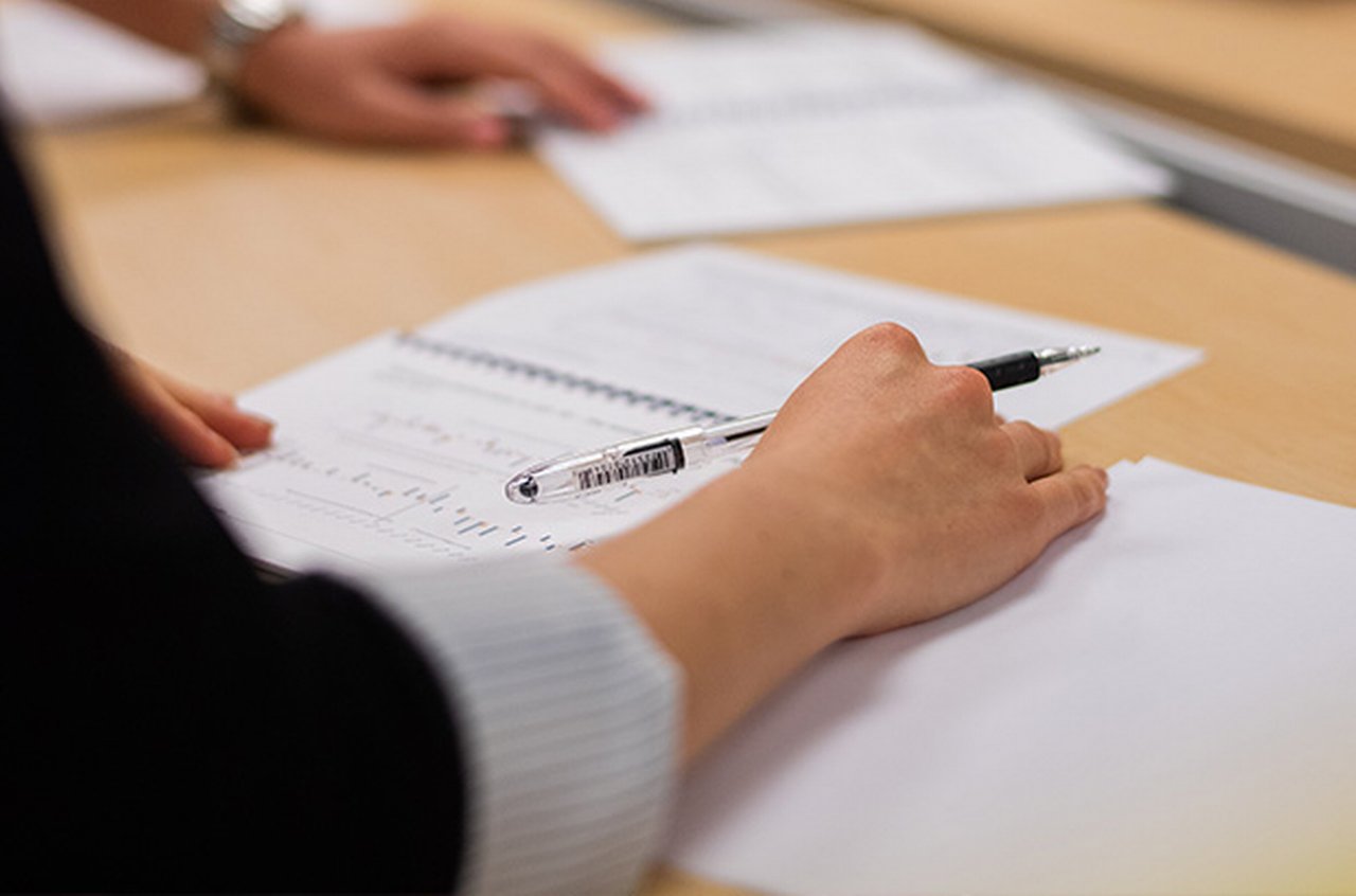 Colleague with pen in hand