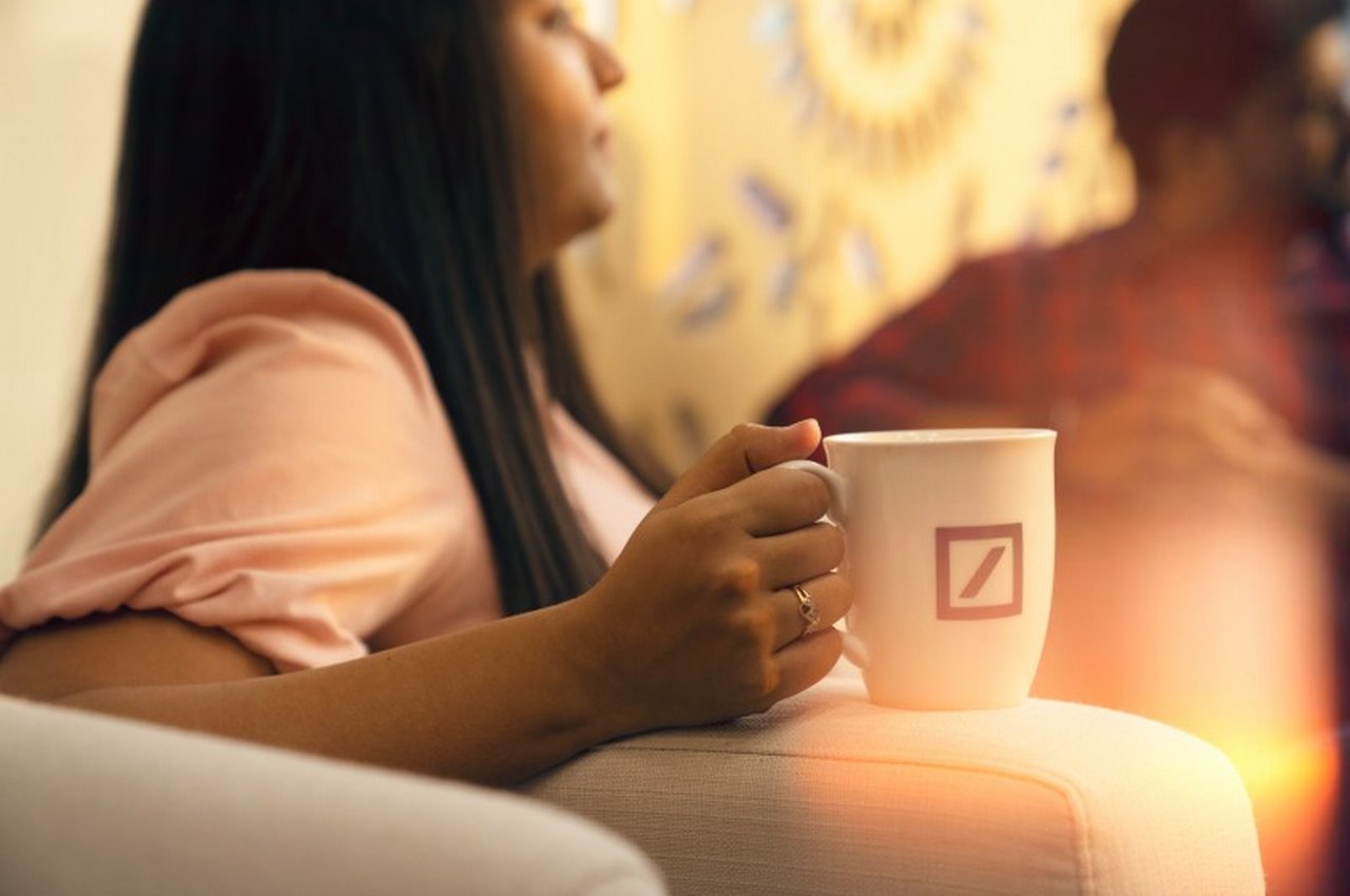 a woman with Deutsche Bank coffee mug