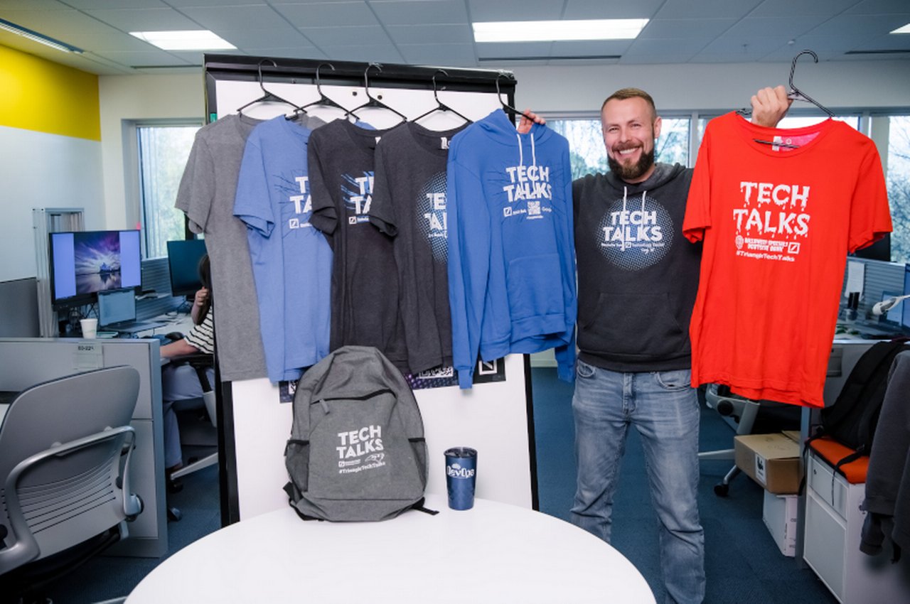 Cary man holding techtalks shirts
