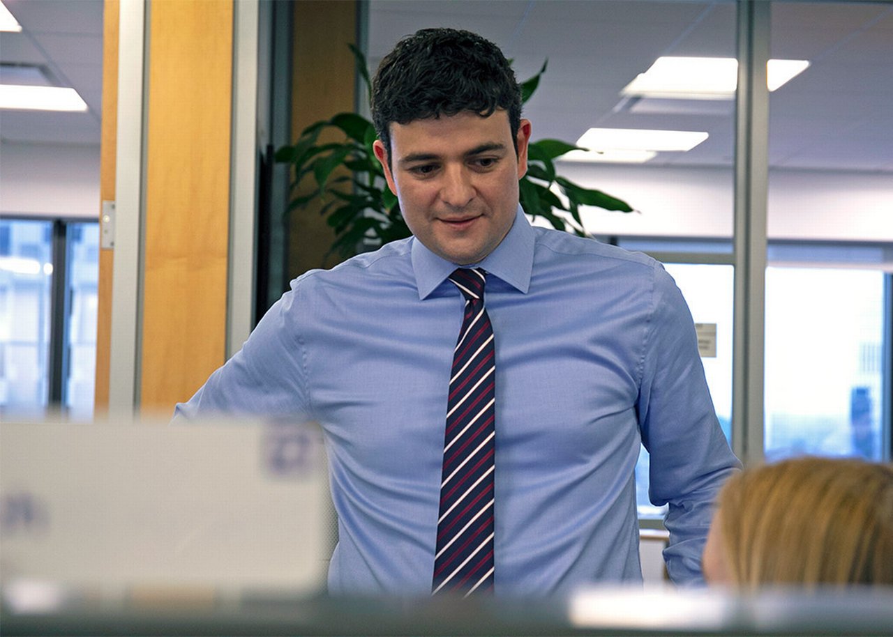 Mike in the office talking with a colleague
