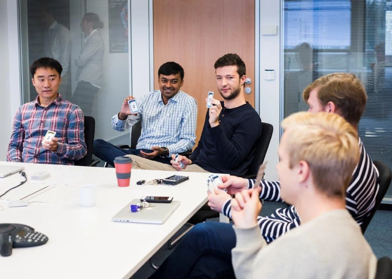 Niklas is sitting with colleagues around a table in a conference room