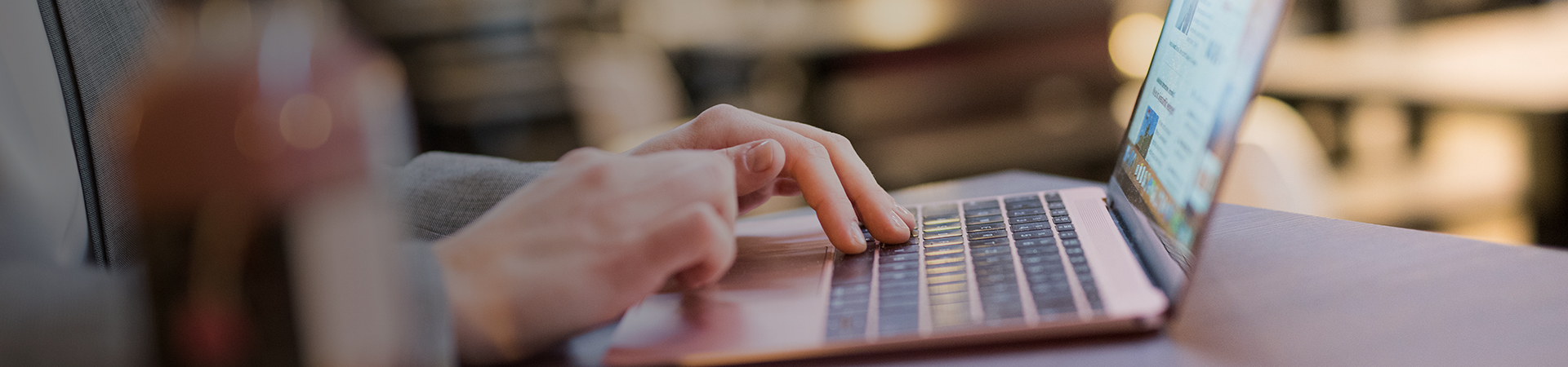 A colleague typing on a laptop